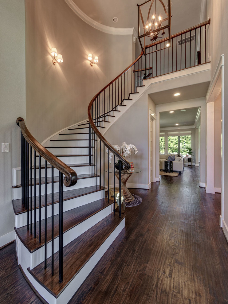 Medium sized vintage wood curved wood railing staircase in Dallas with wood risers.