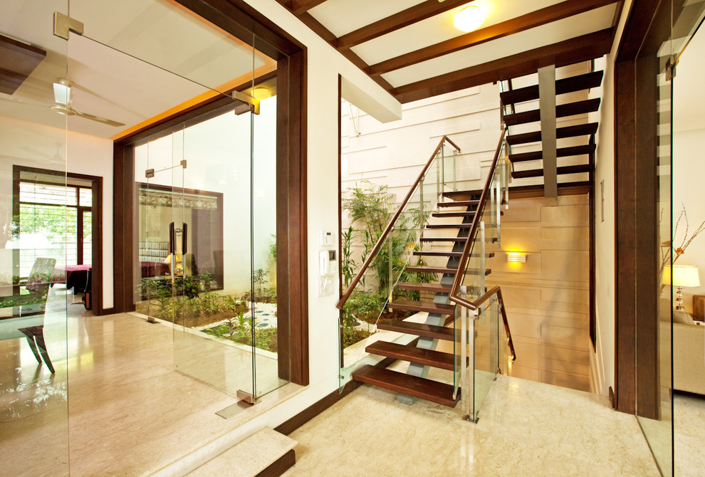 Inspiration for a medium sized contemporary wood floating staircase in Delhi.