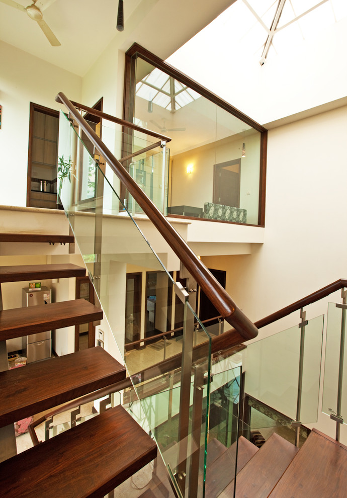 Design ideas for a medium sized contemporary wood floating staircase in Delhi.