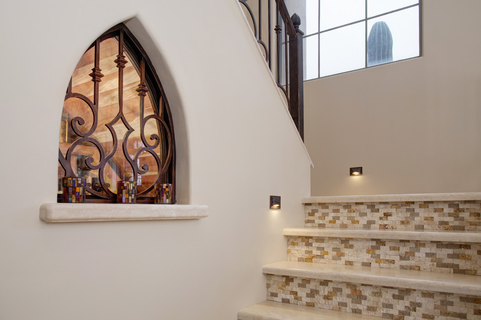 Example of a mid-sized tuscan u-shaped staircase design in Phoenix with tile risers