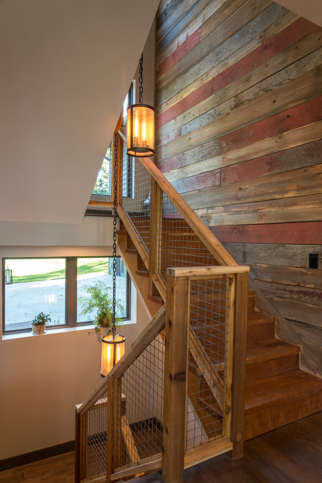 Inspiration for a mid-sized rustic wooden u-shaped staircase remodel in Other with wooden risers