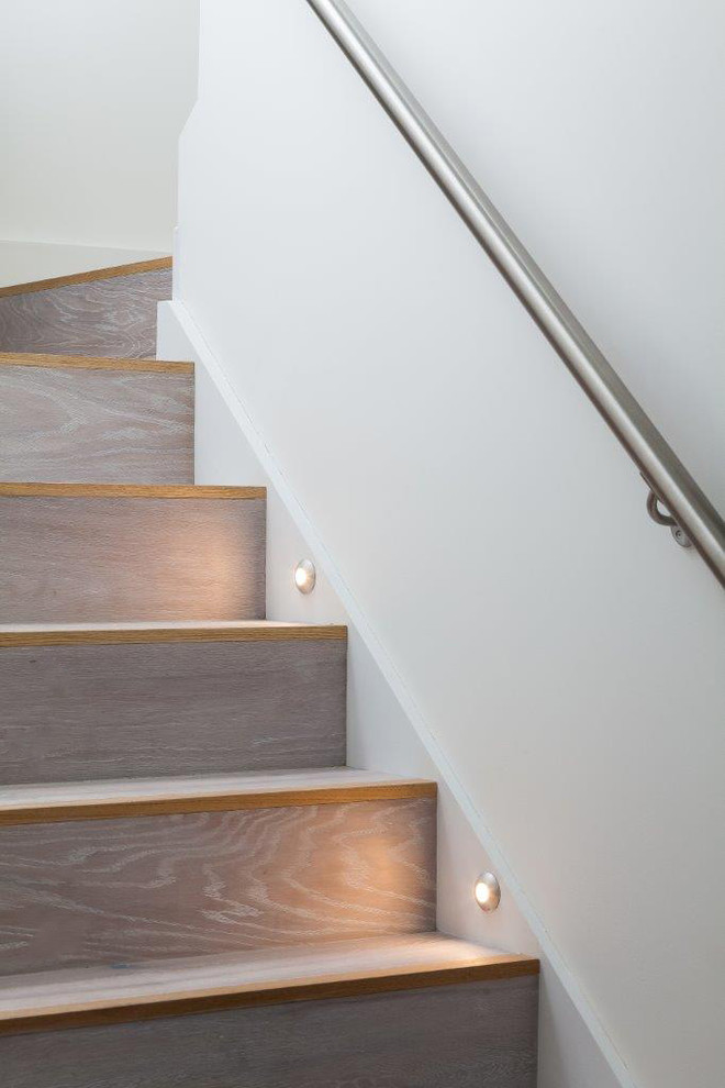 Mid-sized trendy wooden u-shaped staircase photo in Hampshire with wooden risers