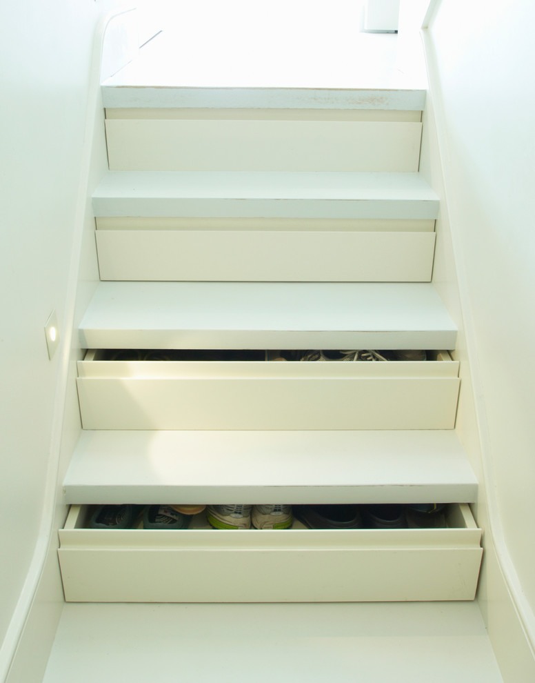 Modern staircase in London with under stair storage.