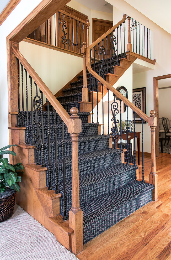 Example of a mid-sized classic carpeted l-shaped mixed material railing staircase design in Milwaukee with carpeted risers
