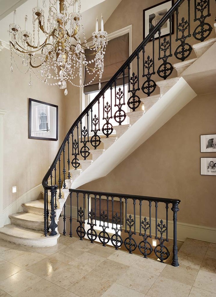 Staircase - traditional curved metal railing staircase idea in Other