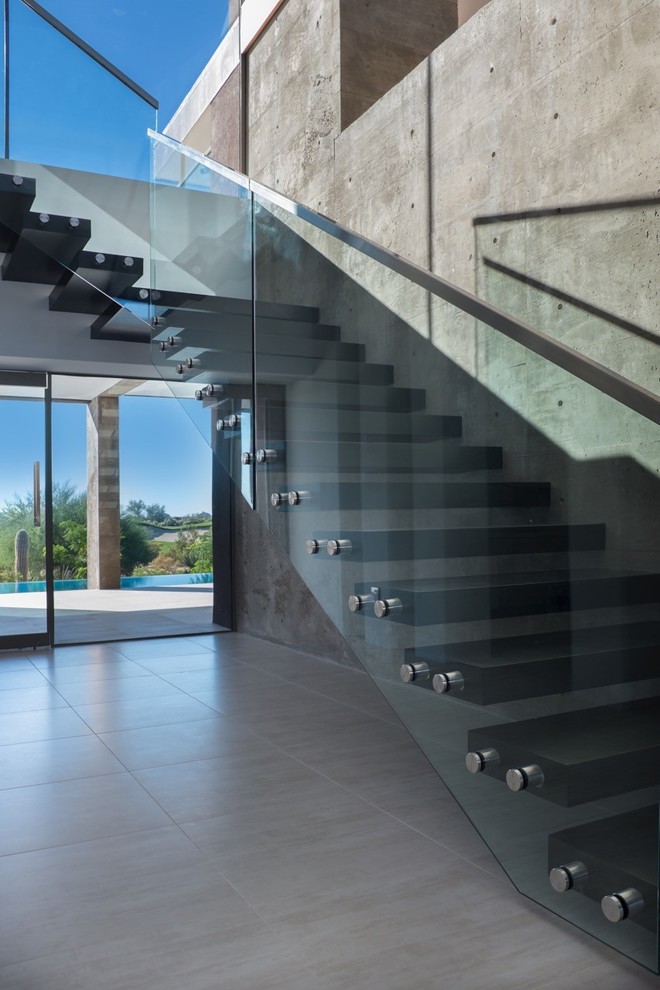 フェニックスにある高級な広いサンタフェスタイルのおしゃれな階段 (ガラスフェンス) の写真