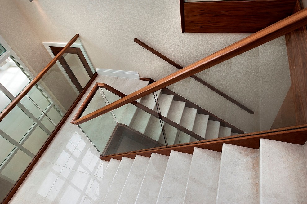 Example of a classic curved staircase design in Surrey
