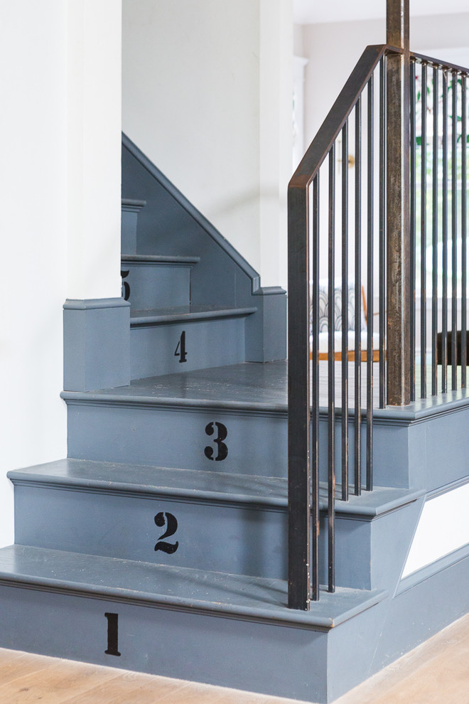 This is an example of a classic painted wood l-shaped staircase in Portland Maine with painted wood risers.