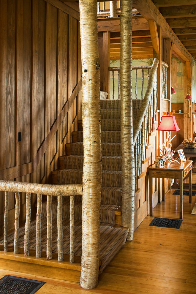 Foto på en rustik l-trappa, med heltäckningsmatta och sättsteg i trä