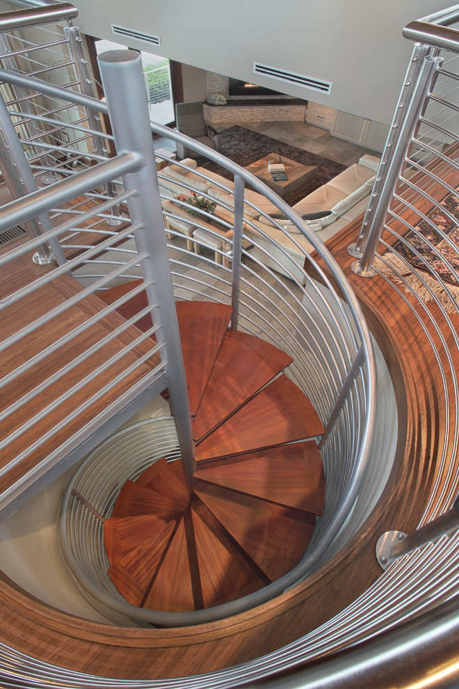 Large contemporary wood spiral staircase in Miami with metal risers.