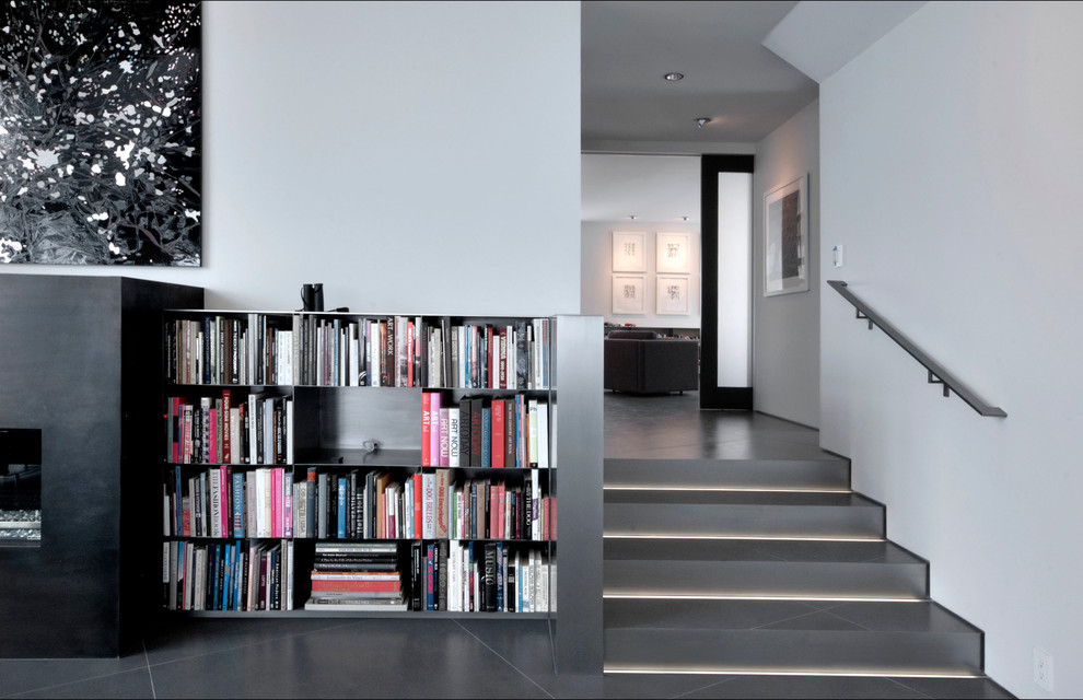 This is an example of a medium sized contemporary tiled straight staircase in Denver with metal risers and feature lighting.