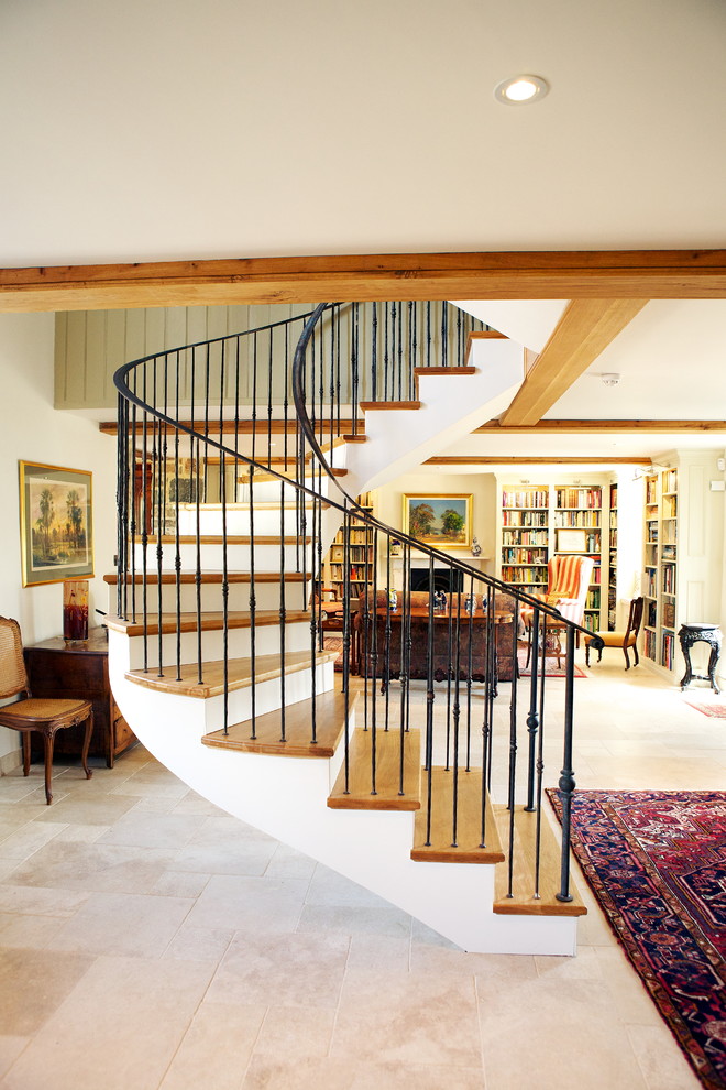 Inspiration for a country wood curved staircase in Channel Islands with wood risers and feature lighting.