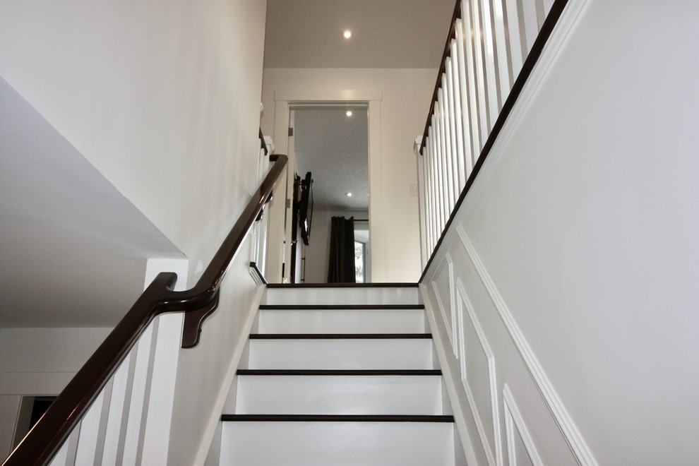 Design ideas for a medium sized traditional wood l-shaped wood railing staircase in Calgary with painted wood risers.