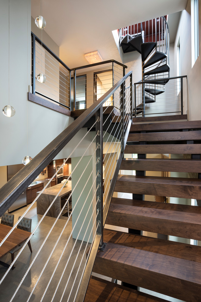 This is an example of a small modern wood floating staircase in Minneapolis with open risers.