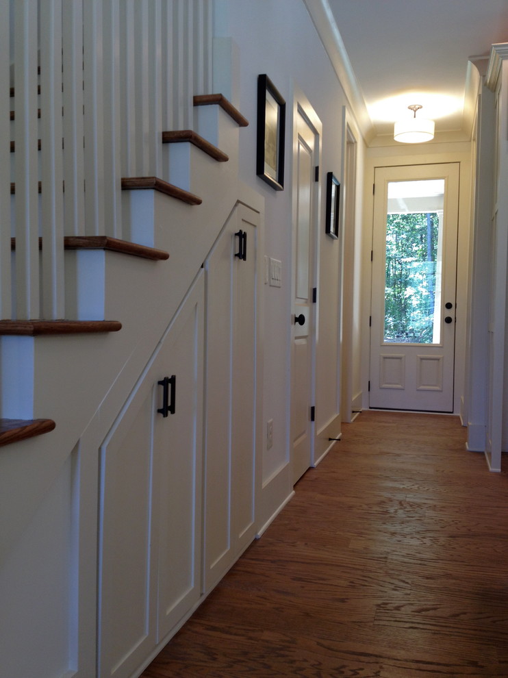 This is an example of a traditional staircase in Atlanta with under stair storage.