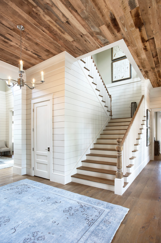 Inspiration for a huge timeless wooden u-shaped staircase remodel in Other with painted risers