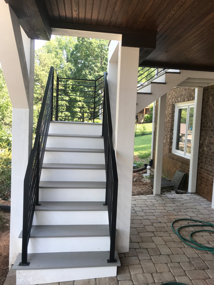Example of a small trendy l-shaped metal railing staircase design in Charlotte