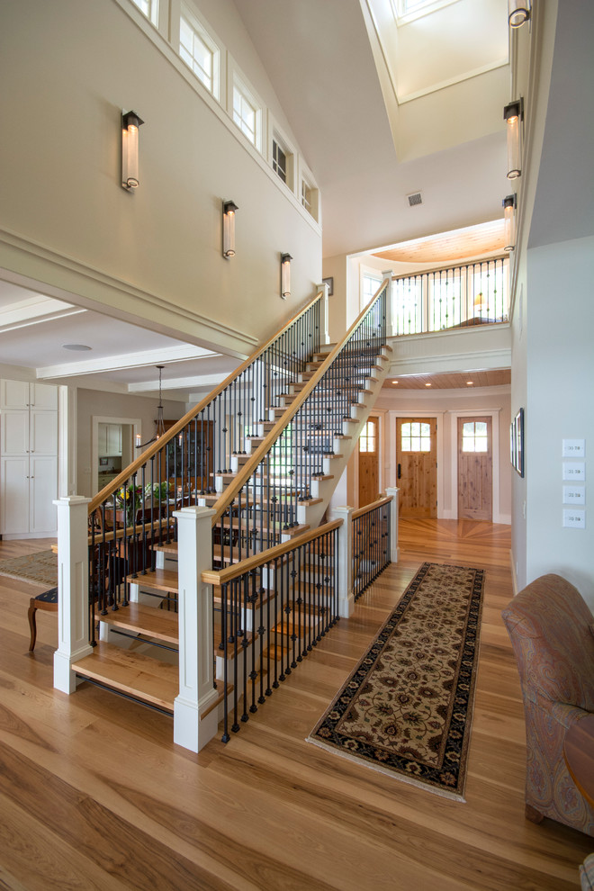 Medium sized classic wood straight staircase in Boston with open risers.
