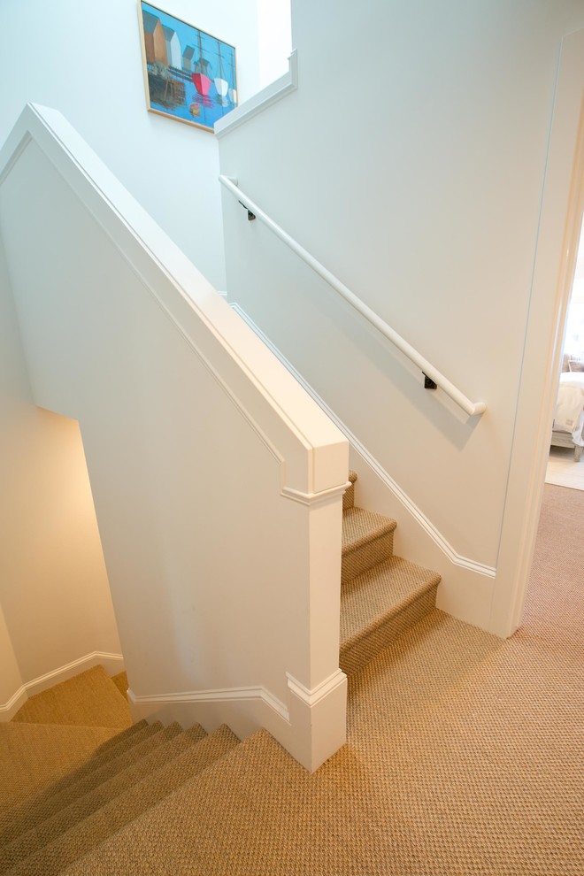 Mid-sized beach style carpeted u-shaped staircase photo in Other with carpeted risers