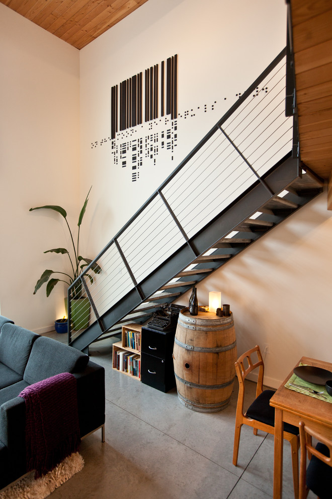 На фото: прямая лестница в стиле лофт с деревянными ступенями и кладовкой или шкафом под ней без подступенок