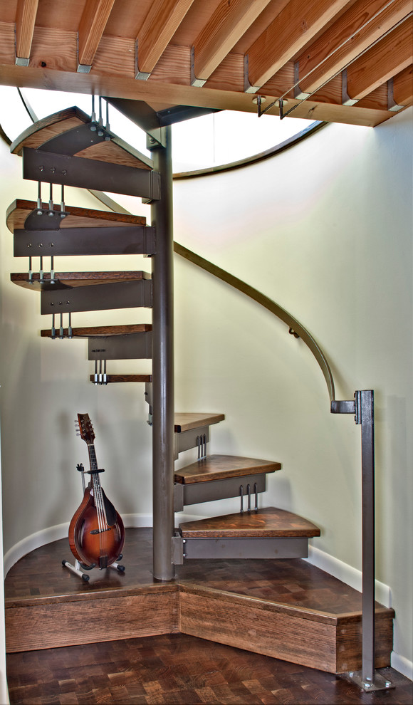 Small trendy wooden spiral open staircase photo in Seattle
