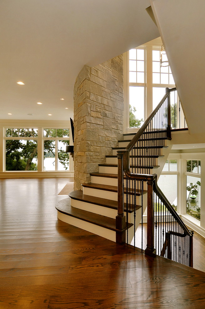 Inspiration for an expansive traditional wood u-shaped staircase in Chicago with painted wood risers.