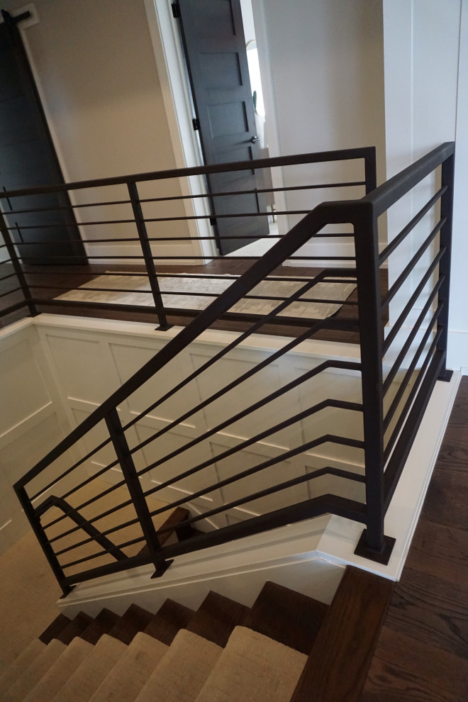 Idée de décoration pour un escalier design en L de taille moyenne avec des marches en métal, des contremarches en métal et un garde-corps en métal.
