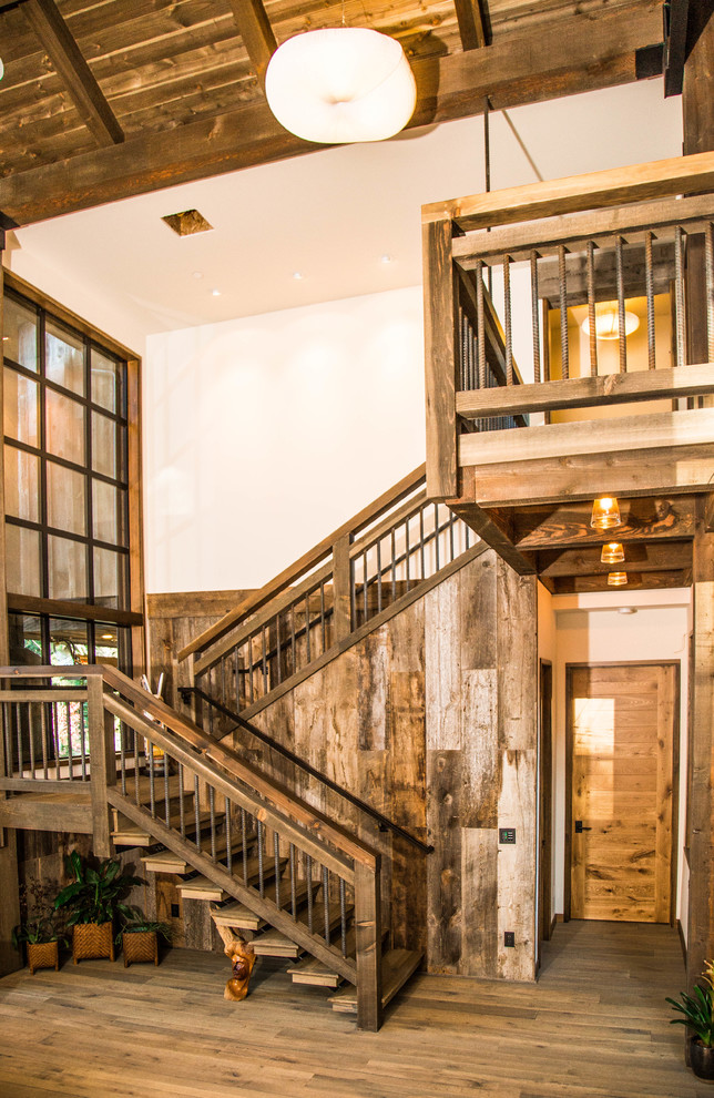 На фото: большая лестница на больцах в стиле модернизм с деревянными ступенями без подступенок с