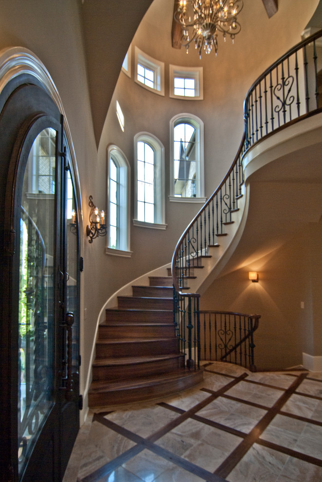 Ejemplo de escalera curva clásica con escalones de madera y contrahuellas de madera