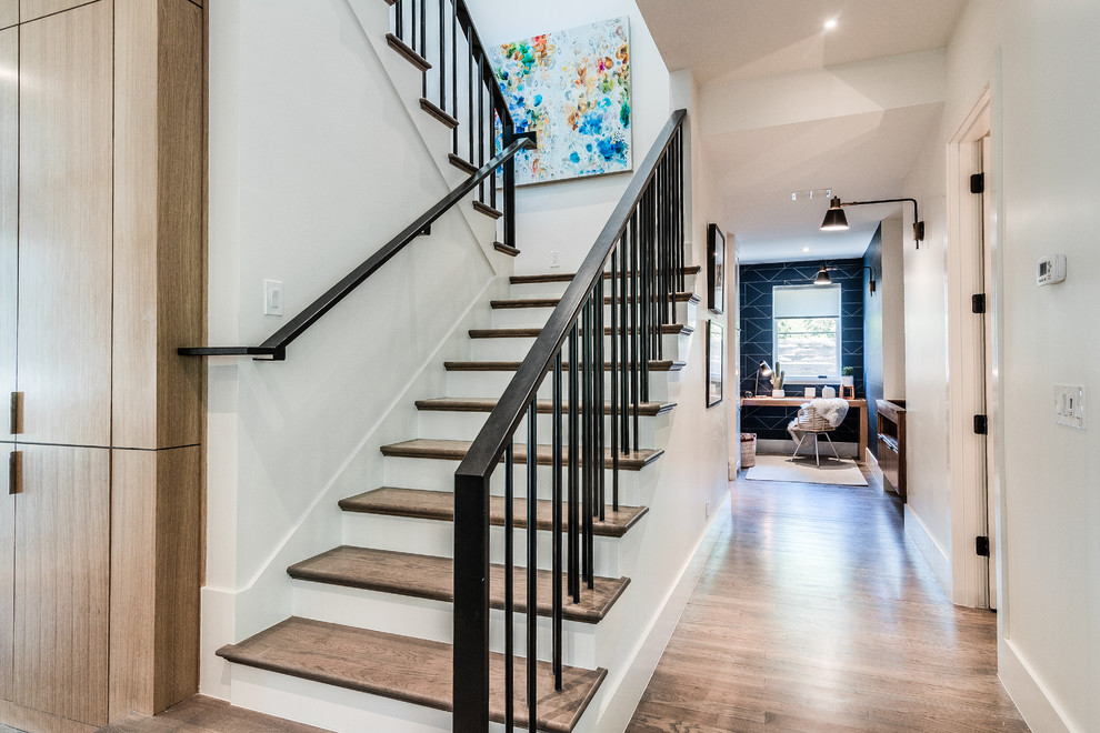 Mid-sized trendy wooden u-shaped metal railing staircase photo in Dallas with wooden risers