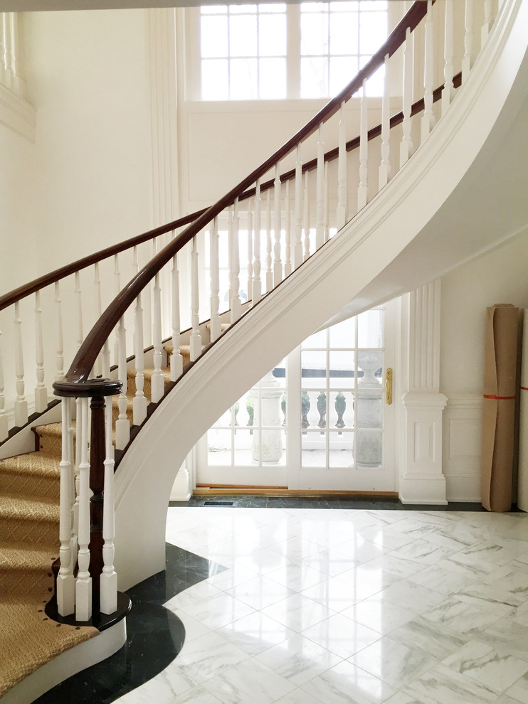 This is an example of a medium sized contemporary carpeted curved staircase in Baltimore with carpeted risers.