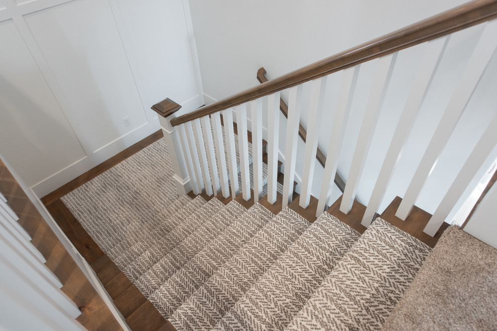 Example of a mid-sized transitional wooden u-shaped wood railing staircase design in Salt Lake City with wooden risers