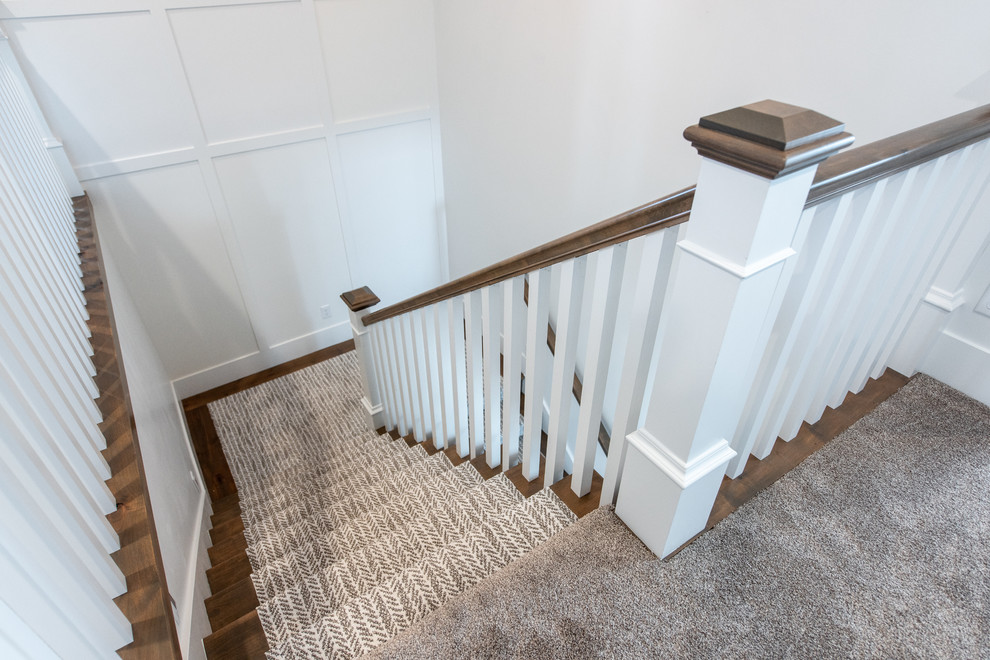 Mid-sized transitional wooden u-shaped wood railing staircase photo in Salt Lake City with wooden risers