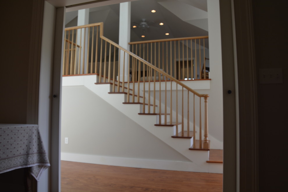 Inspiration for a mid-sized transitional wooden straight wood railing staircase remodel in New York with painted risers
