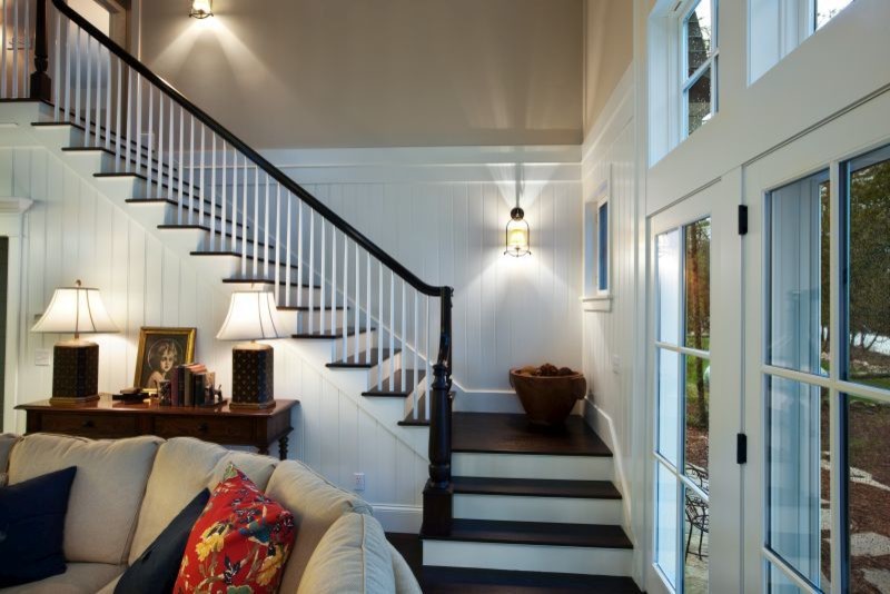 Mid-sized country wooden l-shaped wood railing staircase photo in Other with painted risers