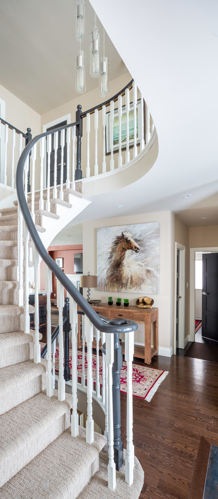 Inspiration for a mid-sized transitional carpeted curved staircase remodel in Toronto with painted risers