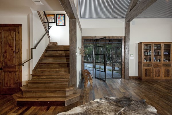 Inspiration for a mid-sized rustic wooden u-shaped metal railing staircase remodel in Austin with wooden risers