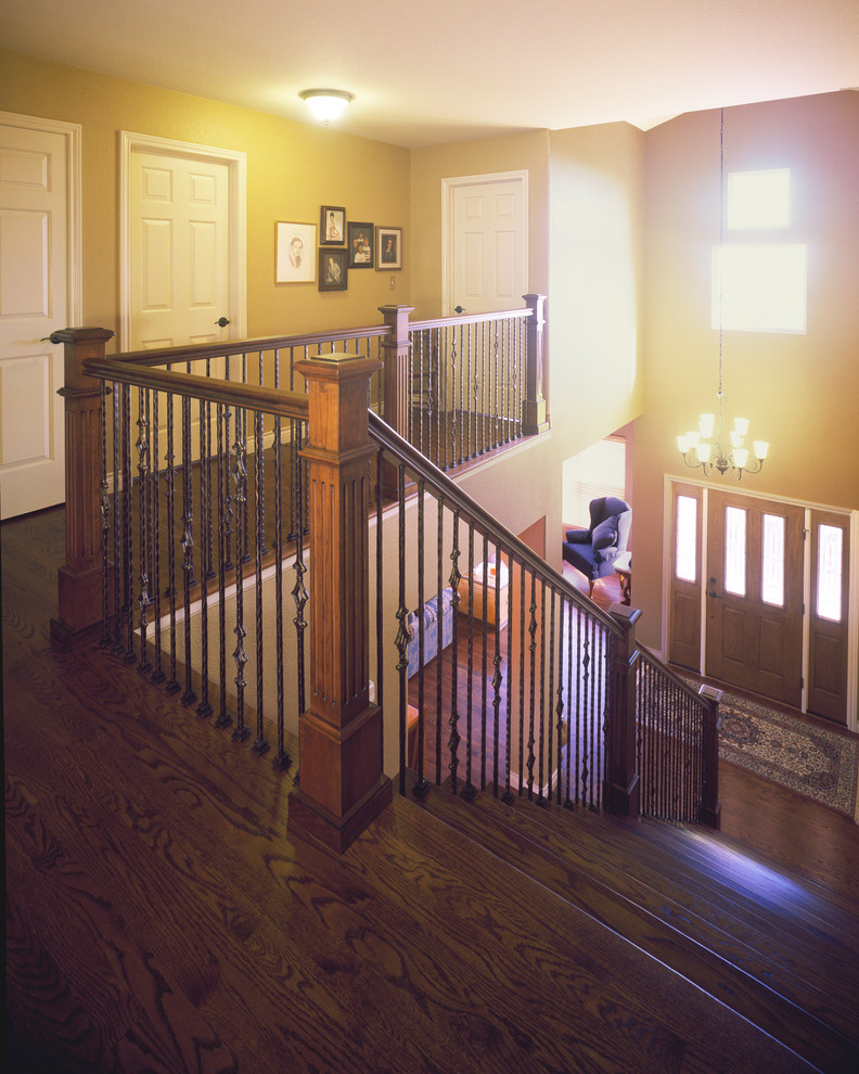 Inspiration for a large classic wood straight staircase in Denver with wood risers.