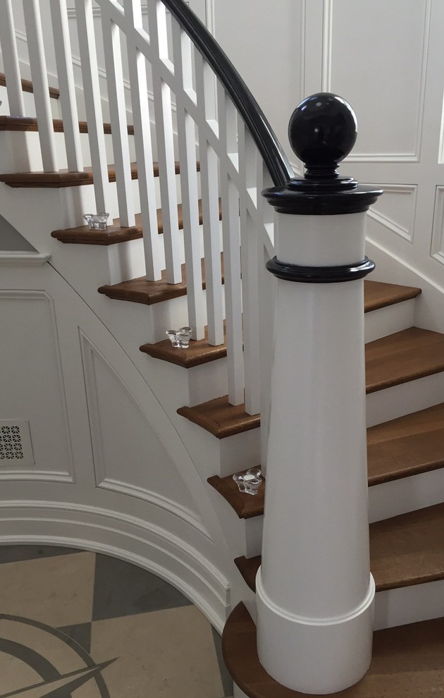 Ejemplo de escalera curva marinera con escalones de madera y contrahuellas de madera