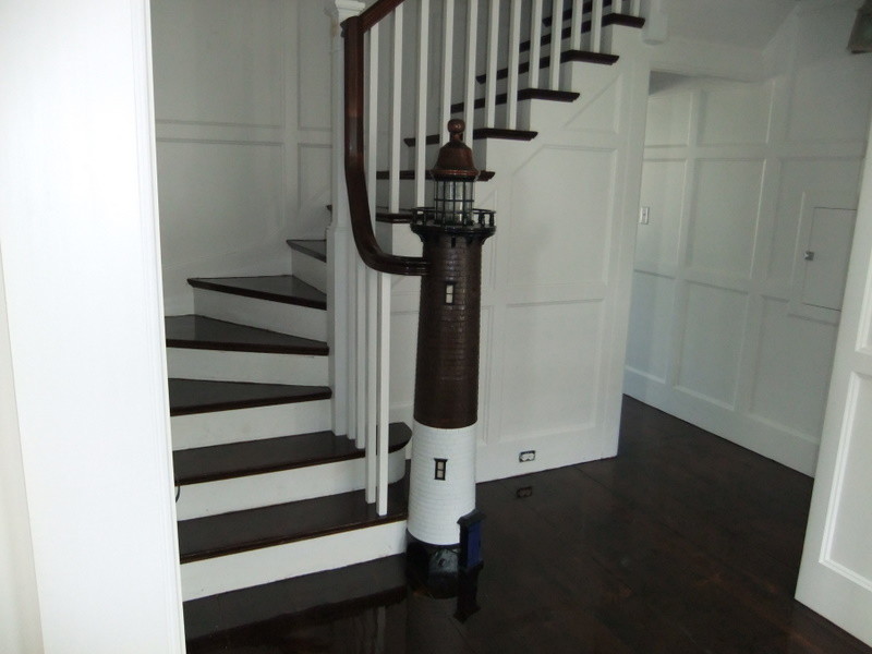 Inspiration for a large coastal wooden curved staircase remodel in Boston with wooden risers