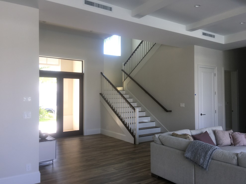 This is an example of a medium sized contemporary wood u-shaped wood railing staircase in Miami with painted wood risers.