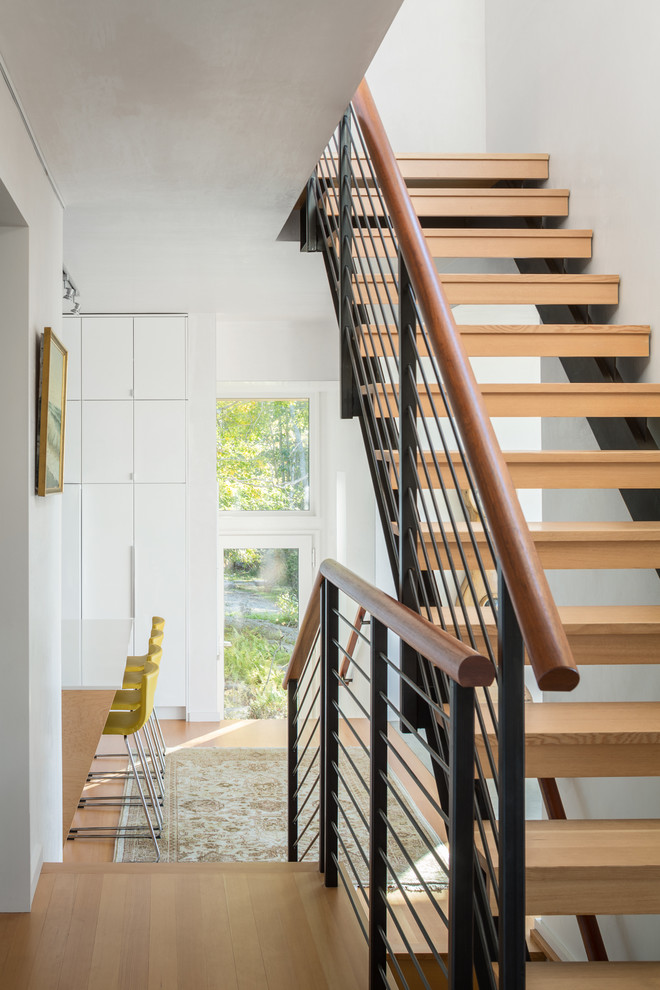 Inspiration for a medium sized contemporary wood straight staircase in Portland Maine with open risers.