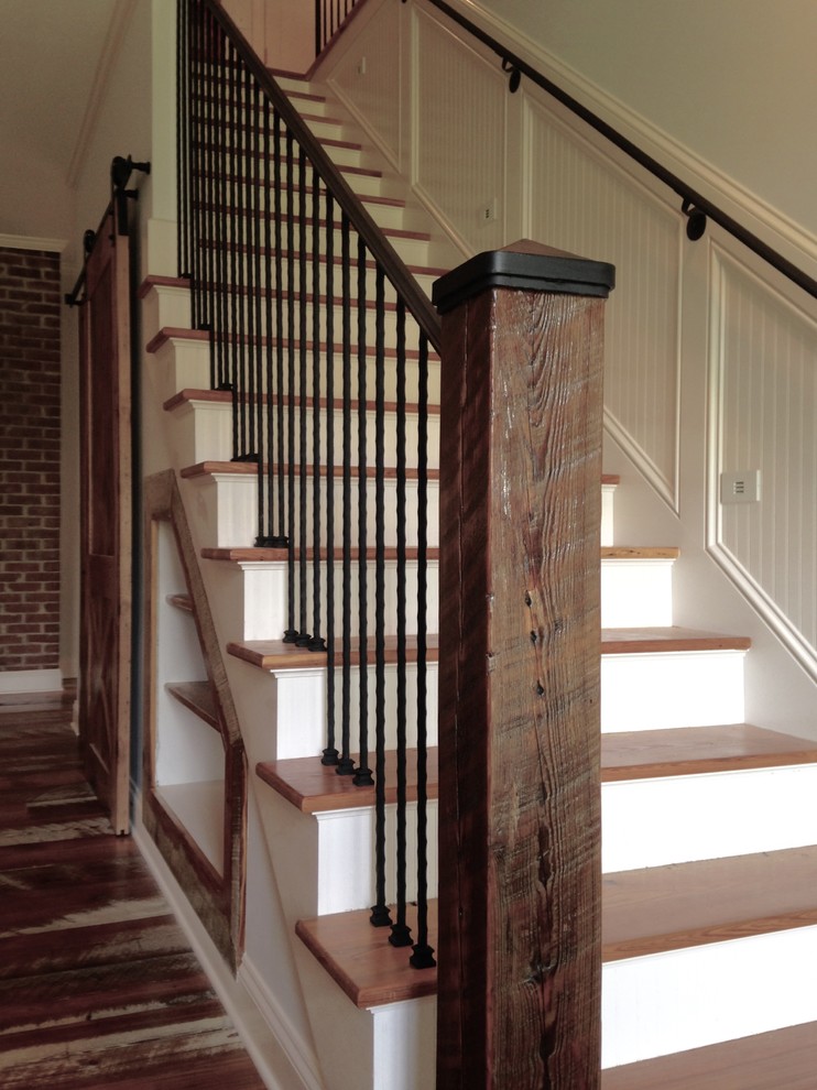 Example of a mid-sized mountain style wooden straight staircase design in Nashville with painted risers