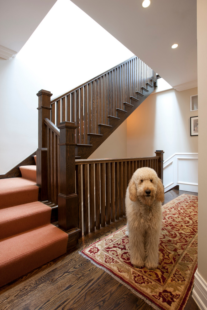 Photo of a classic wood wood railing staircase in Chicago with wood risers.
