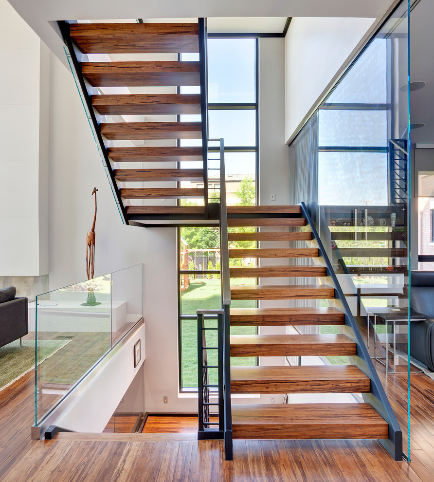 Photo of a contemporary wood u-shaped staircase in Chicago with open risers.