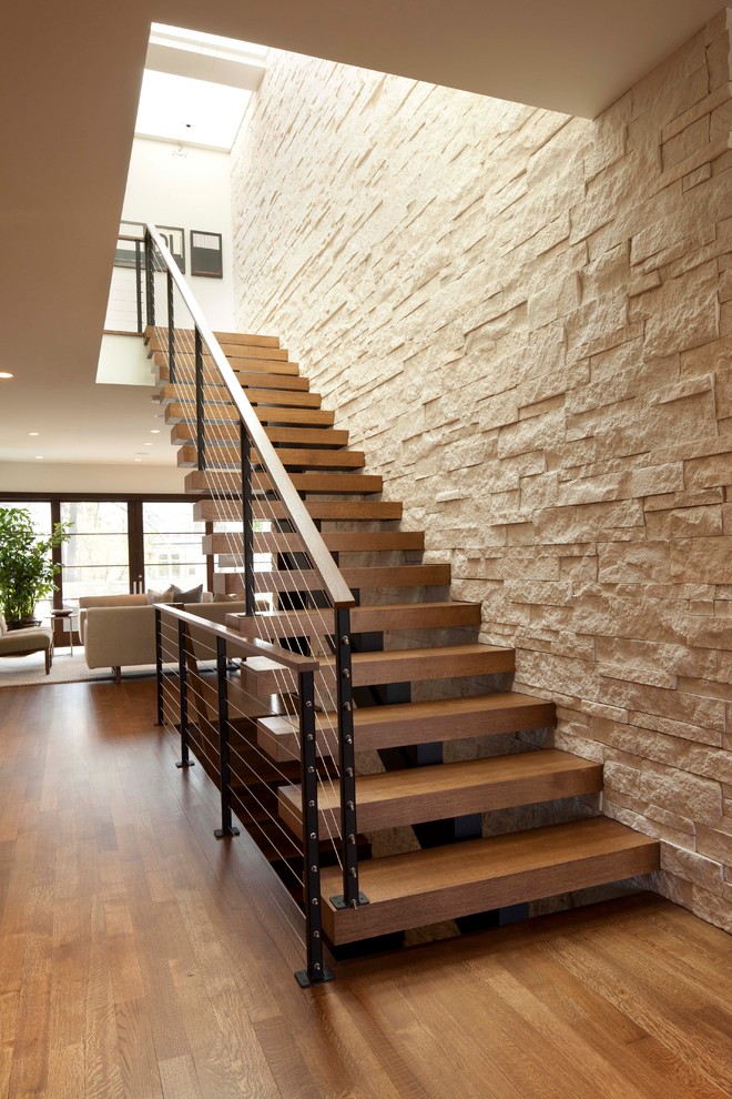 Example of a minimalist wooden straight open and cable railing staircase design in Minneapolis
