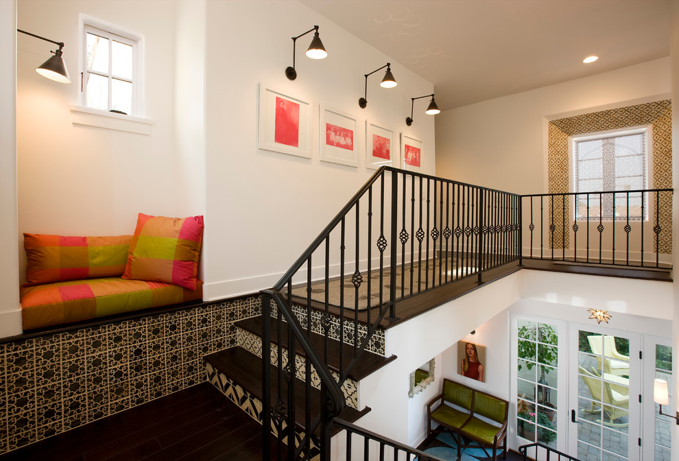 Mediterranean wood staircase in Santa Barbara with tiled risers and feature lighting.