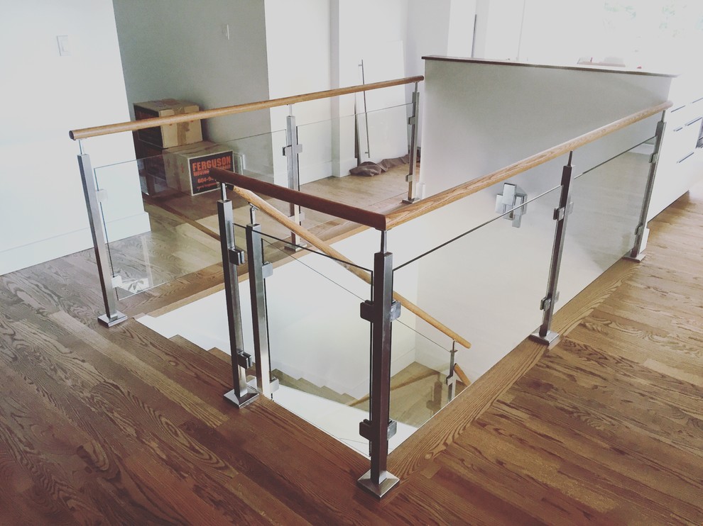 Design ideas for a medium sized traditional wood l-shaped glass railing staircase in Vancouver with painted wood risers.