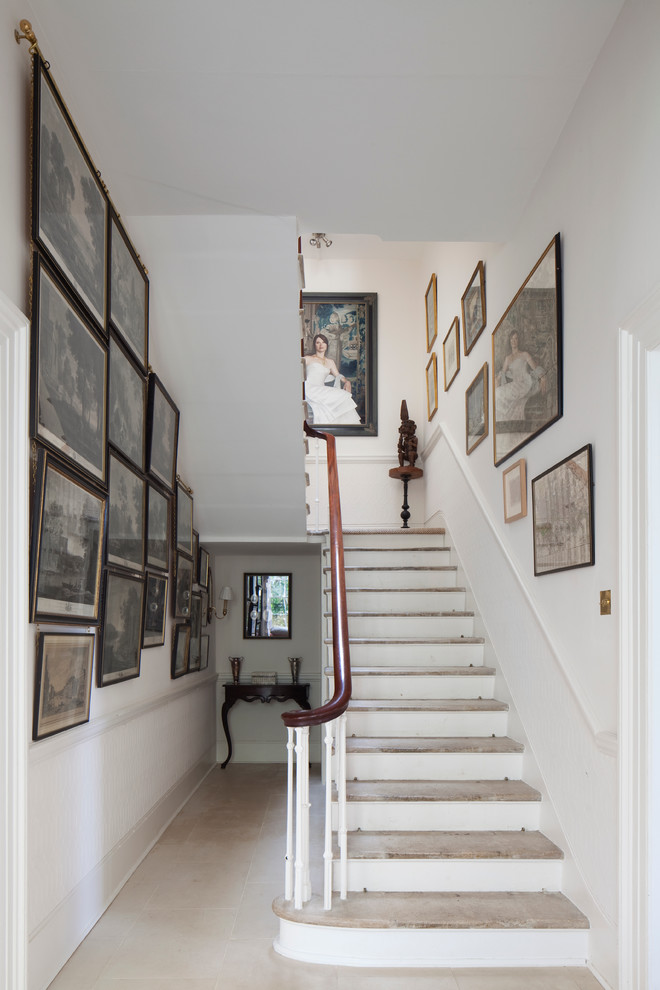 Cette image montre un escalier peint traditionnel en U avec des marches en bois.