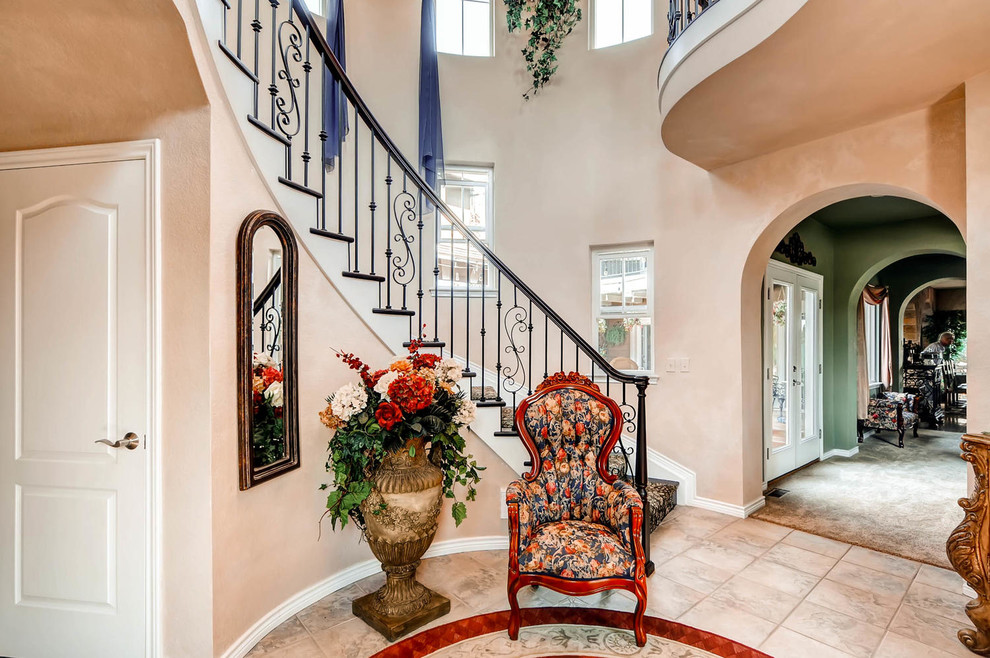 Inspiration for a large timeless carpeted curved staircase remodel in Denver with painted risers